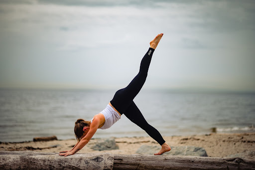 taryn beauvais from the vitality club on the sunshine coast doing yoga on the beach by the ocean.